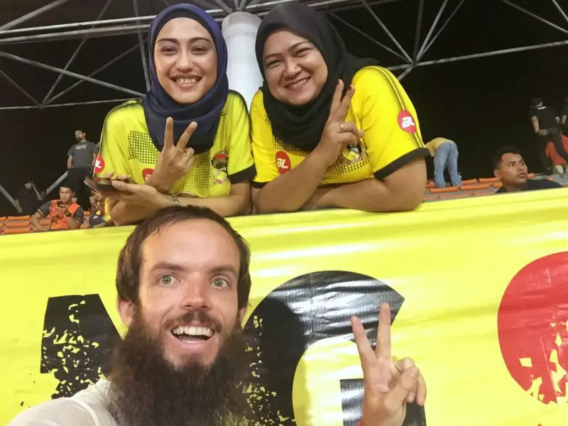 three people doing the peace sign